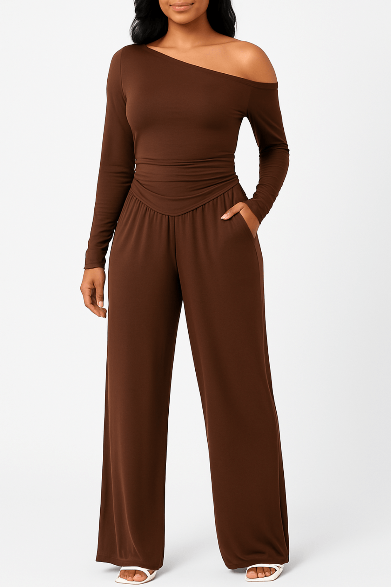 Woman wearing an off-the-shoulder loungewear set with a slouchy top and matching jogger-style pants in soft, stretchy fabric. Cozy two-piece set perfect for relaxing at home or casual outings.
